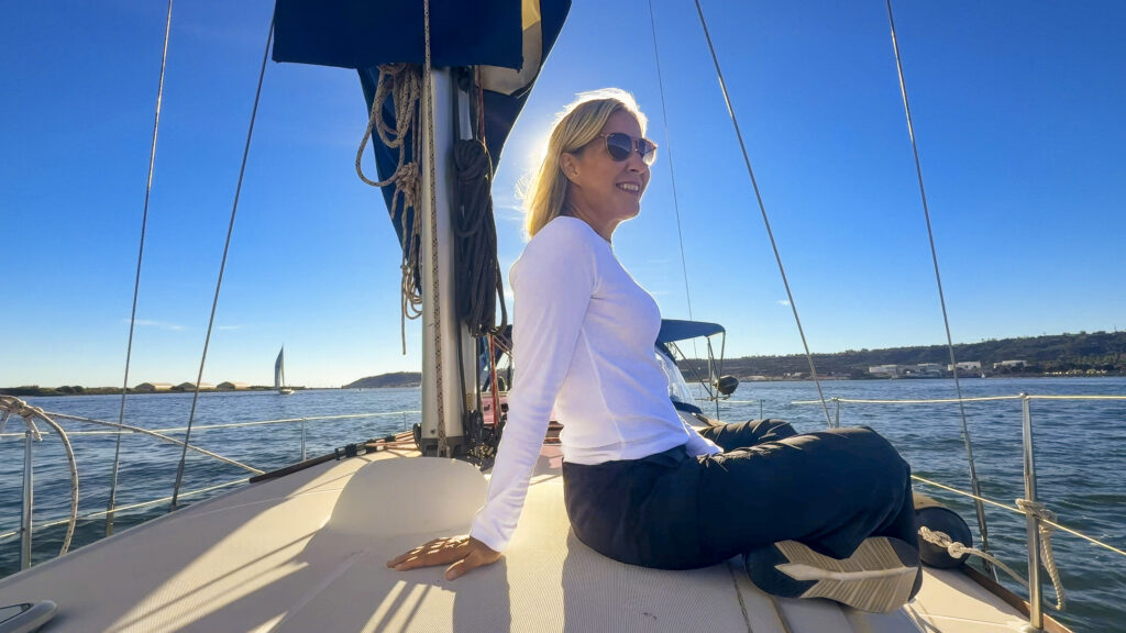 Carolyn sitting on a boat post surgery, enjoying life.