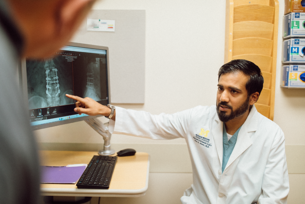 Dr Aleem pointing to spine xray